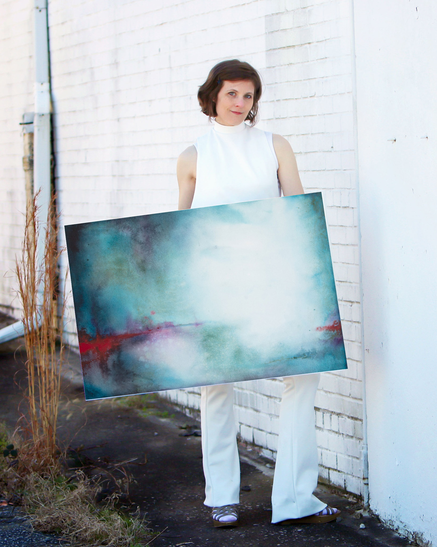 artist holding abstract art in watercolor